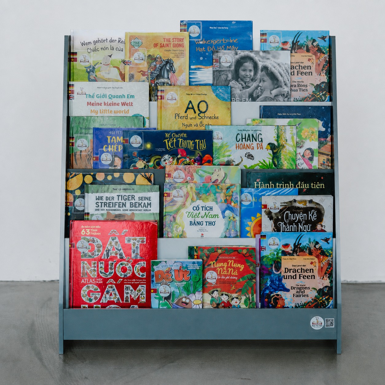 Vietnamese children's books in a blue Mãi Tò Mò book shelf